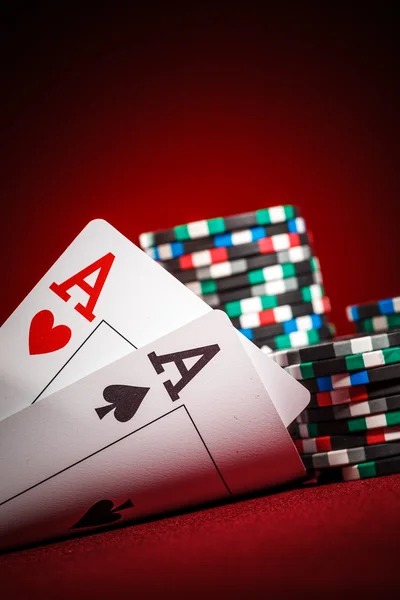 Live-dealer croupier in formal dress managing game table with visible betting layout